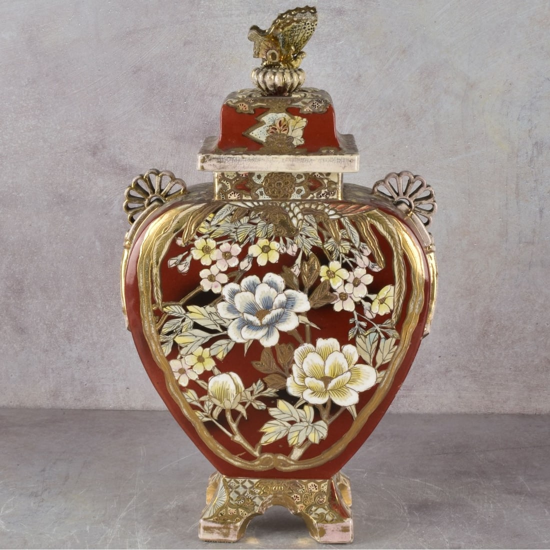 Antique Japanese Kutani Vase: Antique Japanese Kutani Porcelain Vase With Butterfly Finial Cover. Artist signed to the bottom. Measures: 17" high, 9-1/2" wide, 4-1/2" deep. Kodner Galleries offers phone and absentee bidding at a