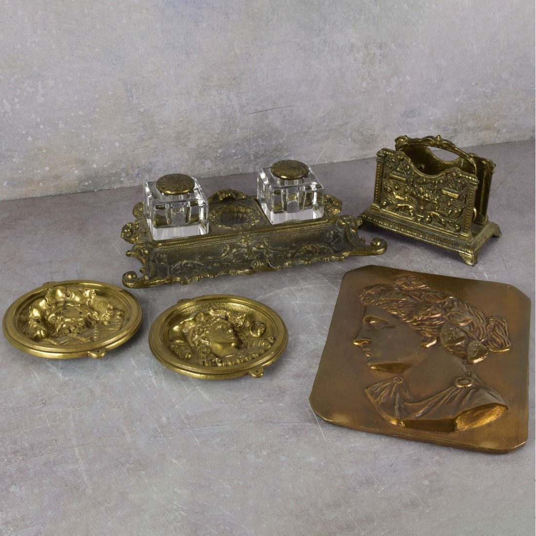 Art Nouveau Gilt Brass Pieces: Collection of Five (5) Art Nouveau Gilt Brass Pieces. Consisting on one (1) ladies profile plaque, measures: 10" high, 7-1/2" wide,one (1) beveled double glass inkwell, measures: 3" high, 11-1/4"
