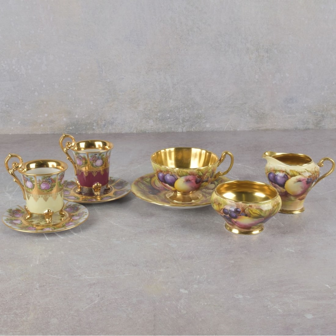 Collection of Continental Porcelain: Collection of Eight (8) Continental Porcelain Pieces. Various makers and motifs, including cups, saucers, creamer and open sugar, creamer measures: 2-1/2" high. Kodner Galleries offers phone and