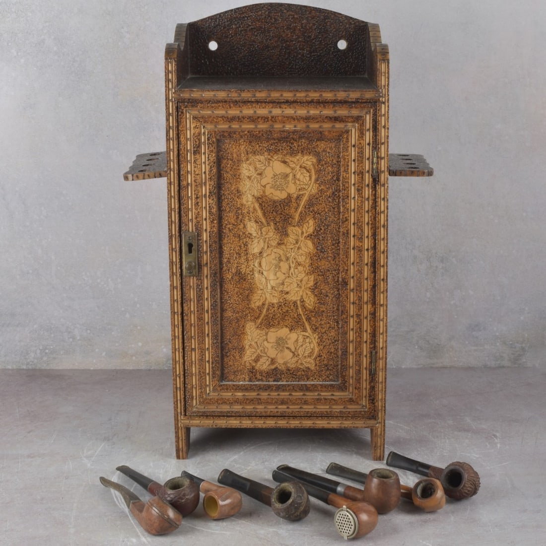Pipe Tobacco Storage Cabinet: Pipe Tobacco Storage Cabinet with a Single Slide Out Drawer and Seven (7) Associated Pipes. Measures: 19-1/2" high, 9-1/4" wide, 7" deep. Kodner Galleries offers phone and absentee bidding at a low,