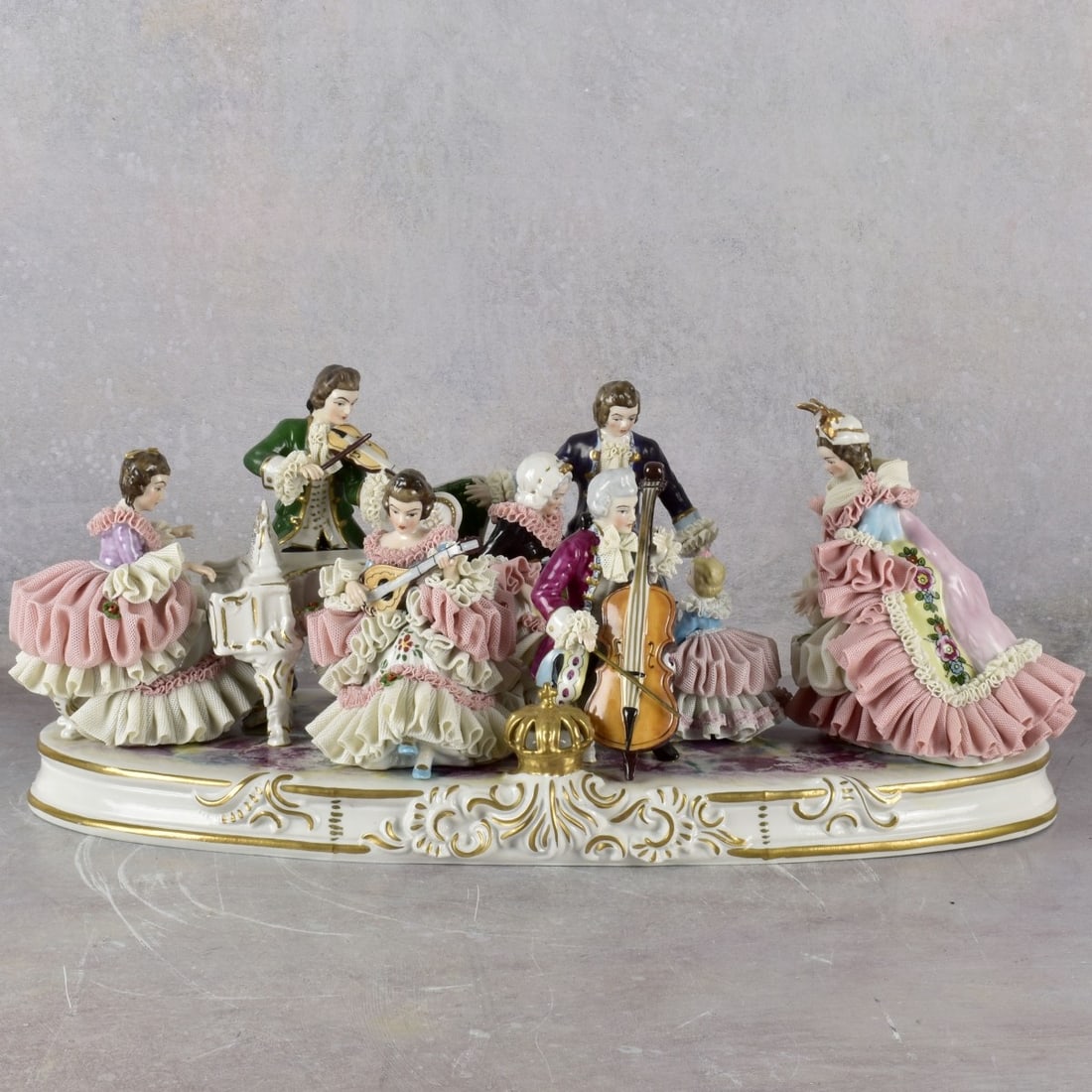 Vintage German Volkstedt-Rudolstadt: Large Vintage German Volkstedt-Rudolstadt Lace Porcelain Sculpture of Musicians and Figures with a Crown to the Front. Stamped with makers mark to the bottom. Measures: 8" high, 19' wide, 8-1/2"