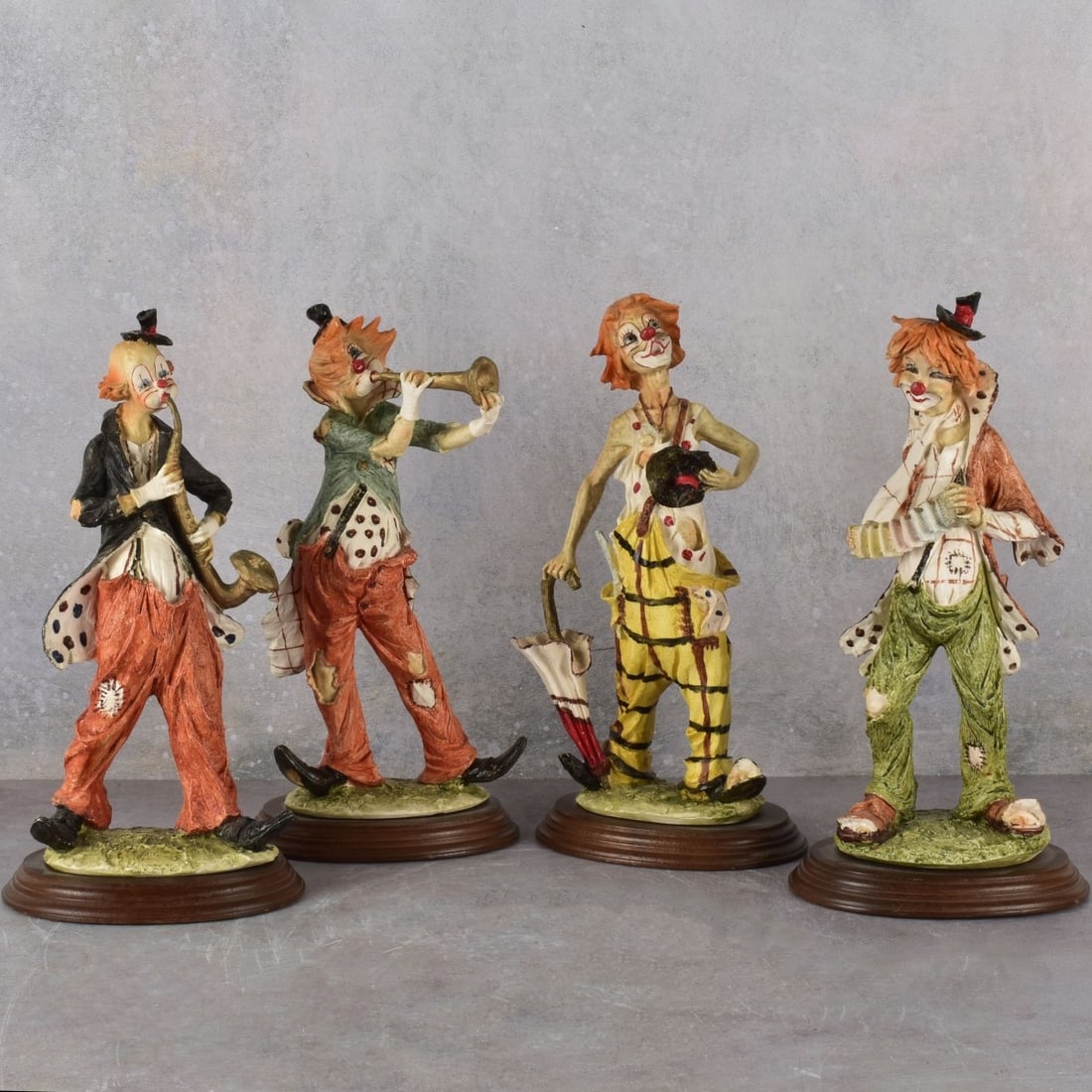 Vintage Pucci Arnart Clowns: Vintage Collection of Four (4) Pucci Arnart Resin Hobo Clown Sculptures. Each signed. Measures: 12" high. Kodner Galleries offers phone and absentee bidding at a low, flat 21% buyer’s premium