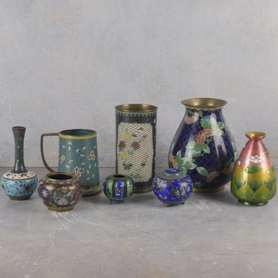 Collection of Cloisonne Pieces: Collection of Eight (8) Cloisonne Pieces. Tallest measures: 8" high, 5-1/2" diameter, smallest measures: 2" high, 2-1/4" diameter. Kodner Galleries offers phone and absentee bidding at a low, flat