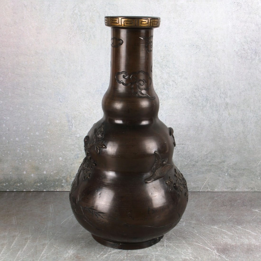 Chinese Double Gourd Bronze Vase: Late 20th Century Chinese Double Gourd Heavy Walled Bronze Vase Decorated in high relief with a floral motif and small flying birds and a long tail phoenix bird. Artist signed to the bottom. Kodner