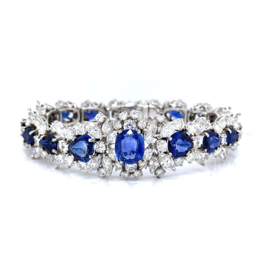 Sapphire, Diamond and Platinum Bracelet: Fine Vintage Circa 1950s Approx. 31.56 Carat TW Oval Cut and Pear Shape Sapphire, 13.5 Carat TW Round Brilliant and Marquise Cut Diamond and Platinum Link Bracelet. Set in the center with a 3.56 carat