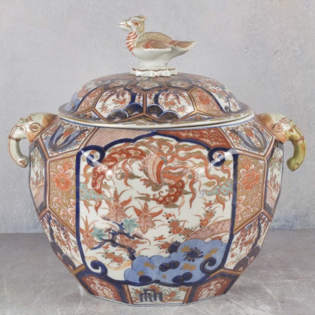 Circa 1900 Japanese Imari Tureen: Circa 1900 Japanese Imari Tureen with a Top Cover Having a Bird Finial and Attached Stylized Elephant Mask Handles to Both Sides. Measures: 14" high, 15" wide, 12" deep. Kodner Galleries offers phone