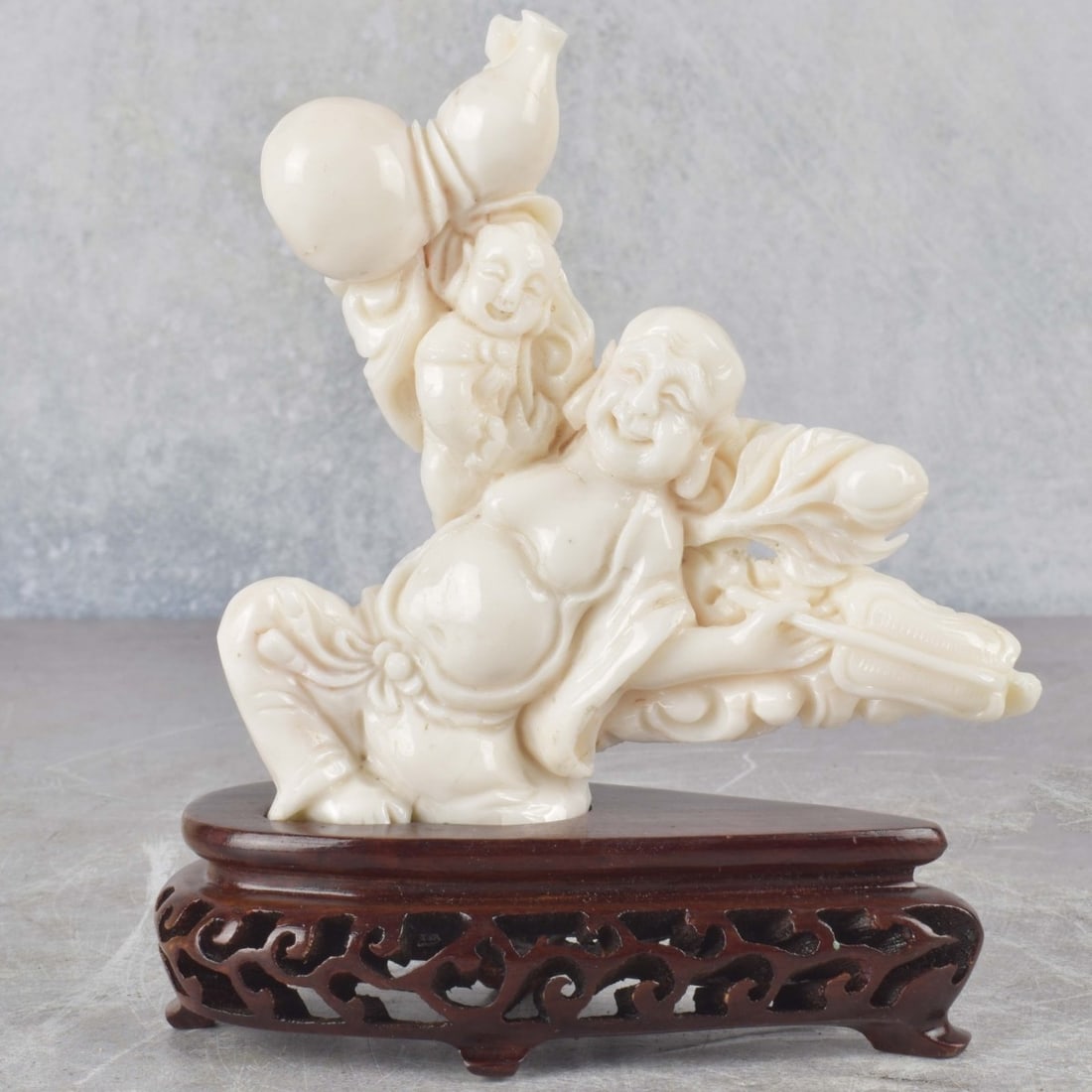 Antique White Coral Carving of a Hoti: Antique White Coral Carving of a Hoti and Attendant on a Carved Wood Base. Sculpture measures: 4-3/8" high, 4-1/4" wide, 1" deep, base measures: 1-1/8" high. We Will Not Ship This Item Outside of the