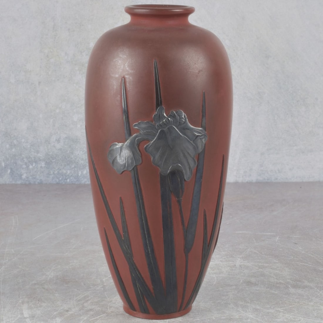 Japanese Bronze Vase with Silver Overlay: Antique Japanese Bronze Vase with Silver Overlay Iris on a Terre-cotta Color Ground. Measures: 7-1/2" high, 3" diameter. Kodner Galleries offers phone and absentee bidding at a low, flat 21% buyer’s
