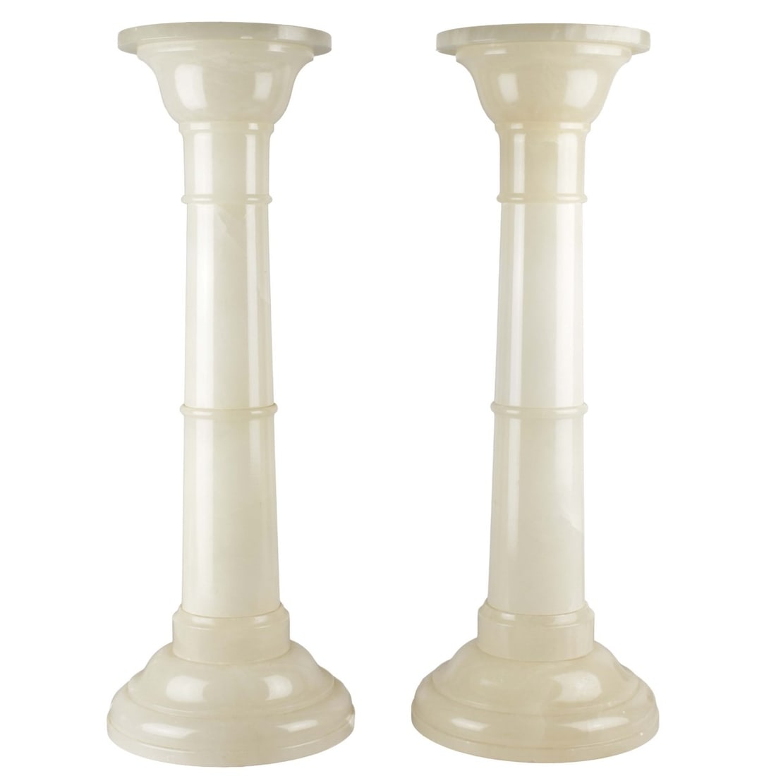 Pair of Alabaster Pedestals: Pair of Vintage Polished White Alabaster Lighted Pedestals. Measures 30-3/4" H, top measures 9-1/8" diam.; base measures 12" diam. Condition: Chips to underside edge of tops. Lights are working but th