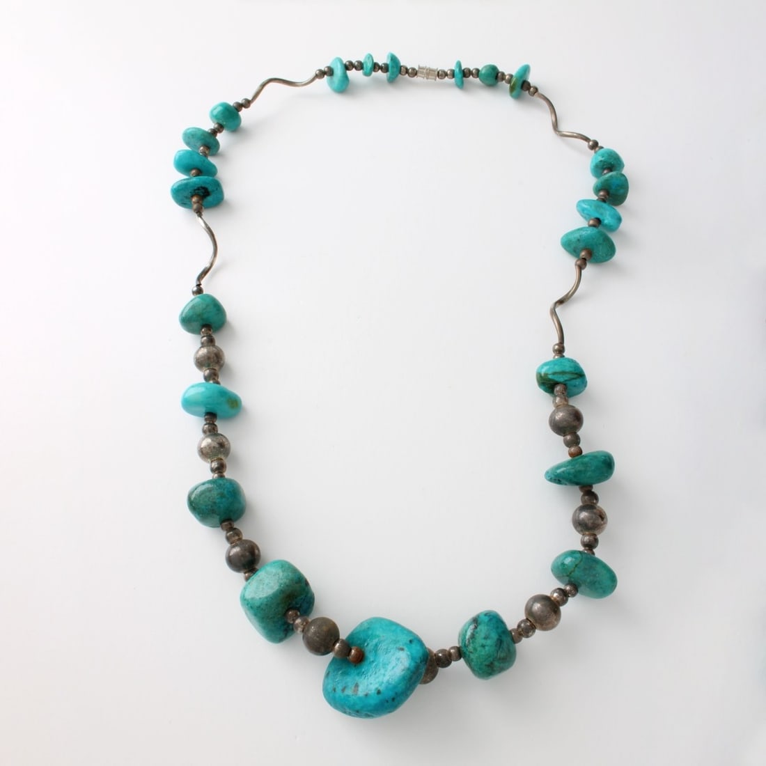 Turquoise and Silver Necklace: Vintage Turquoise Nugget and Silver Necklace. Largest nugget measures 1-1/8" x 1-1/8". Necklace measures 23" L. Approx. weight: 88.21 grams. Condition: Good vintage condition. Estimate: $200.00 -