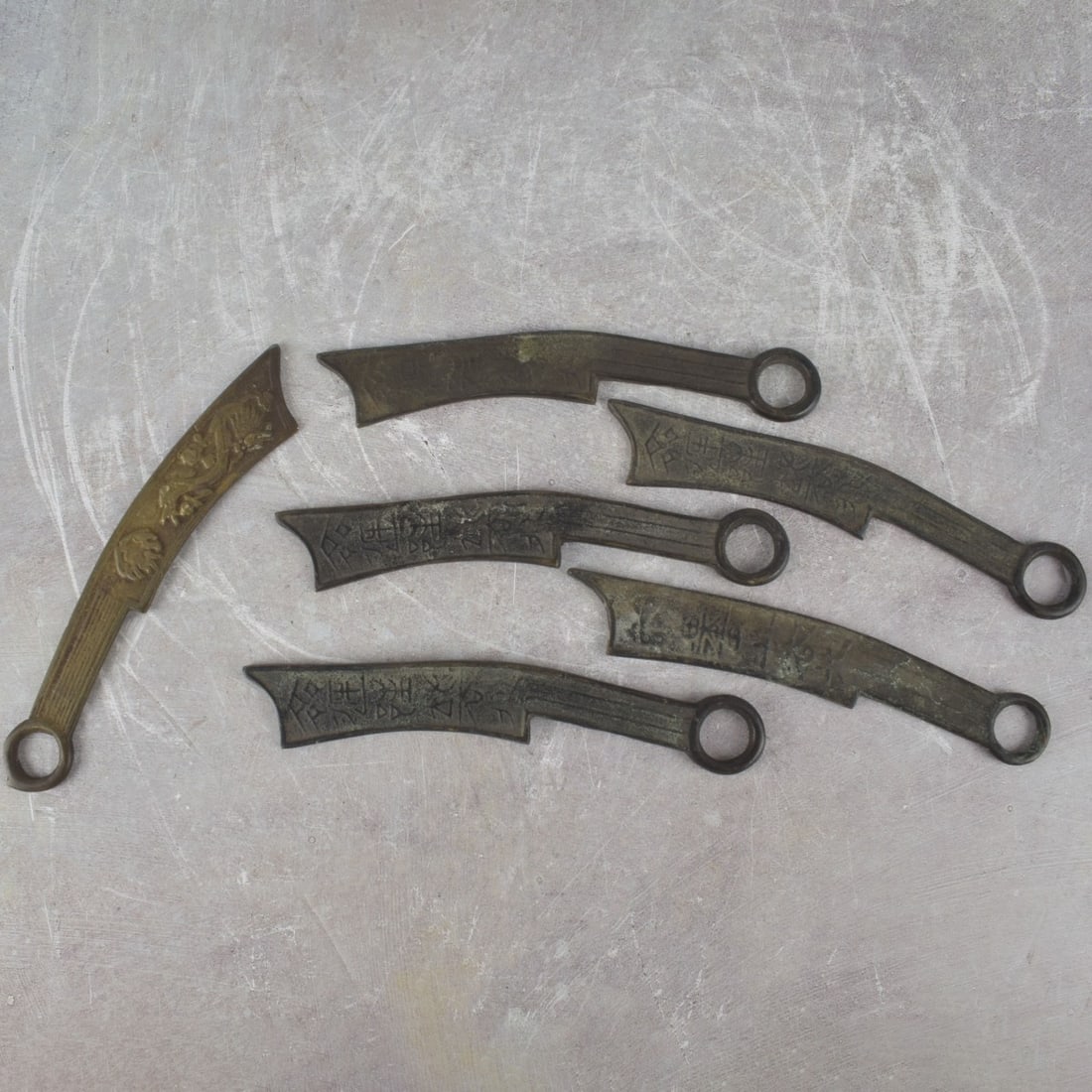 Antique Chinese Knife Money: Six (6) Pieces Antique Bronze Ming Tao Chinese Knife Money. Measures: 6-1/2" long. Kodner Galleries offers phone and absentee bidding at a low, flat 21% buyer’s premium without surcharge or hidden
