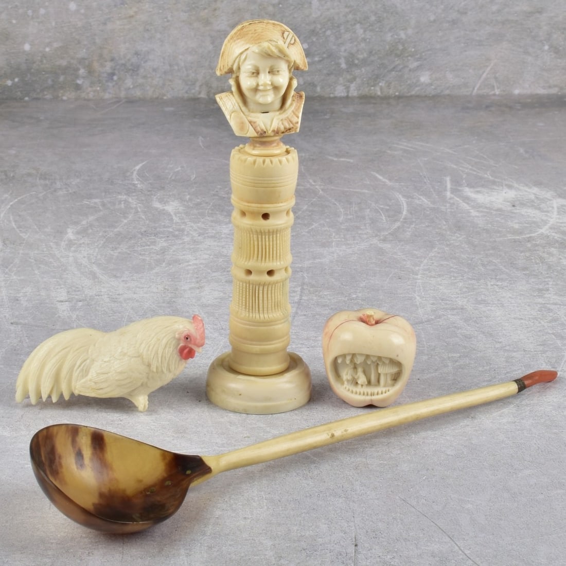 Antique Pieces of Various Carved Items: Four (4) Pieces of Various Antique Carved Items. Including one (1) young Jester on a pedestal, measures: 5-3/4" high, one (1) poly chromed apple with a small carved hut under a tree, measures: 1-1/2"