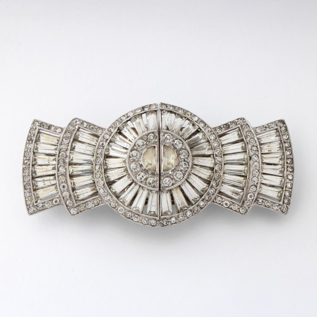 Deco style Clip Brooch: High Quality Vintage Art Deco style Rhinestone and White Metal Double Clip Brooch. Seems to be signed (illegible). Measures 1-1/8" H, 2-1/2" W. Kodner Galleries offers phone and absentee bidding at a 
