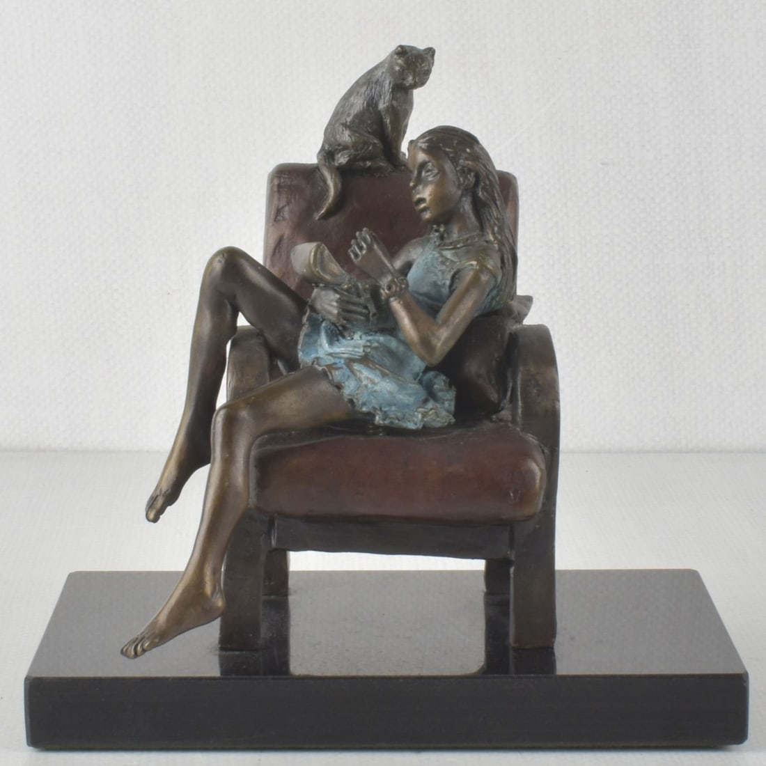 Richard Shiloh, Polish / Israeli (1946 - 2012): Richard Shiloh, Polish / Israeli (1946 - 2012) Bronze Sculpture of a Seated Young Girl Reading a Book with a Small Cat Looking Down Towards Her Mounted to a Marble Base. Engraved "R. Shiloh A.P." to t