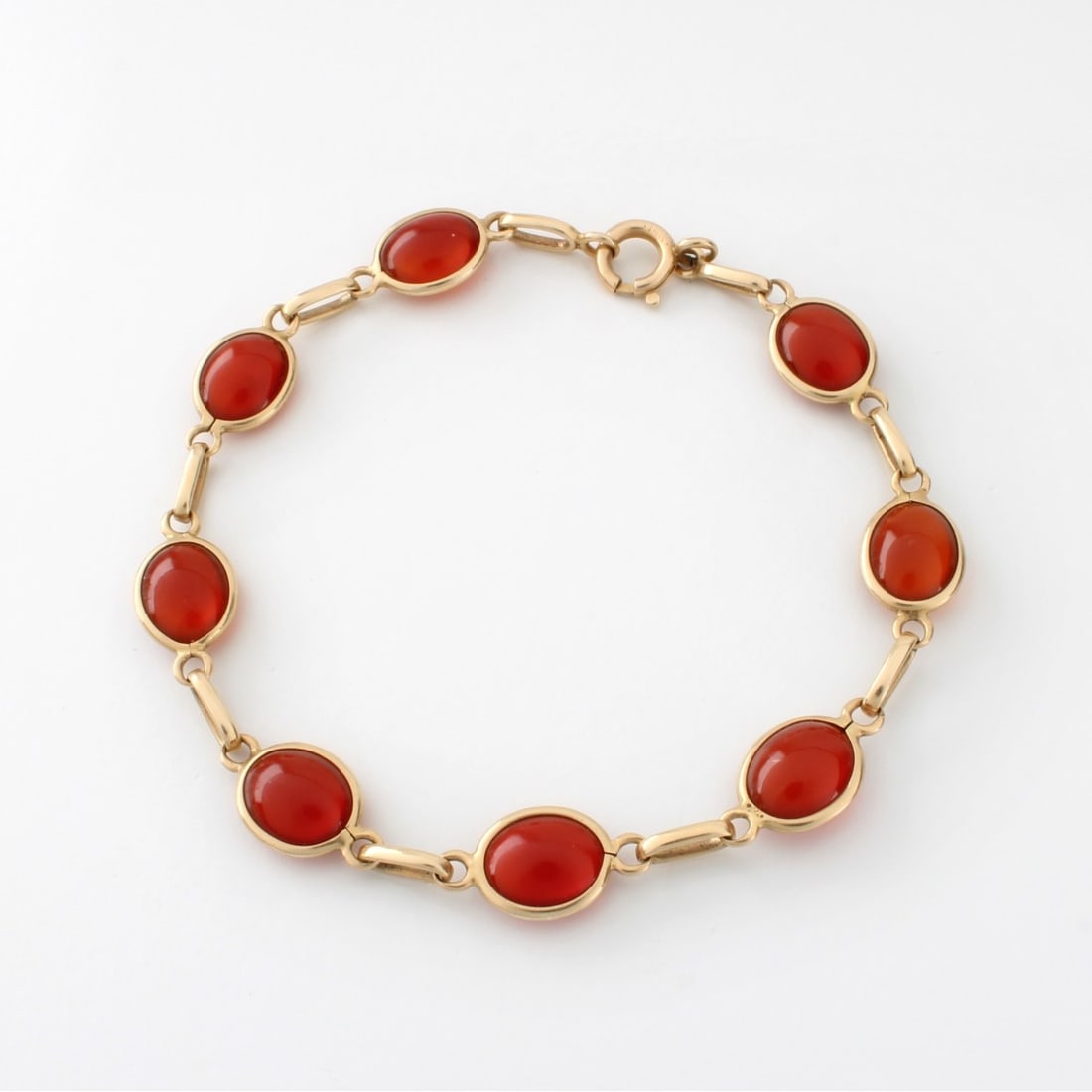 Carnelian and 14K Bracelet: Vintage Eight (8) Oval Cabochon Carnelian and 14 Karat Yellow Gold Link Bracelet. Measures 7-7/8" L, 3/8" W. Approx. weight: 8.70 grams. Kodner Galleries offers phone and absentee bidding at a low,