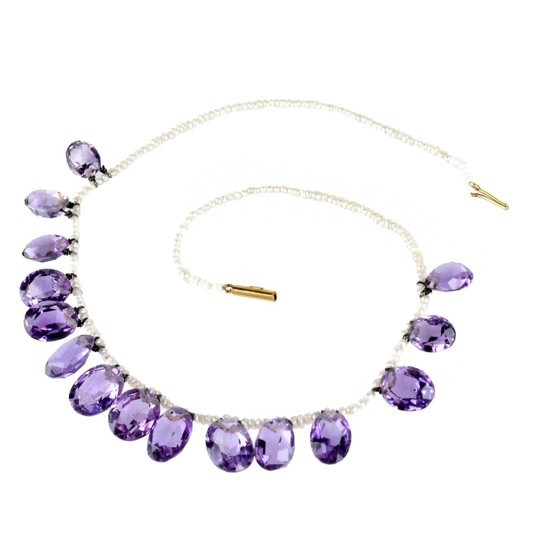 Amethyst, Seed Pearl and 15K Necklace: Antique Fifteen Graduated Oval Cut Amethyst and Seed Pearl Necklace with 15 Karat Yellow Gold Clasp. Amethysts with good color and clarity. Clasp stamped 15K. Measures 14-1/4" L. Approx. weight: