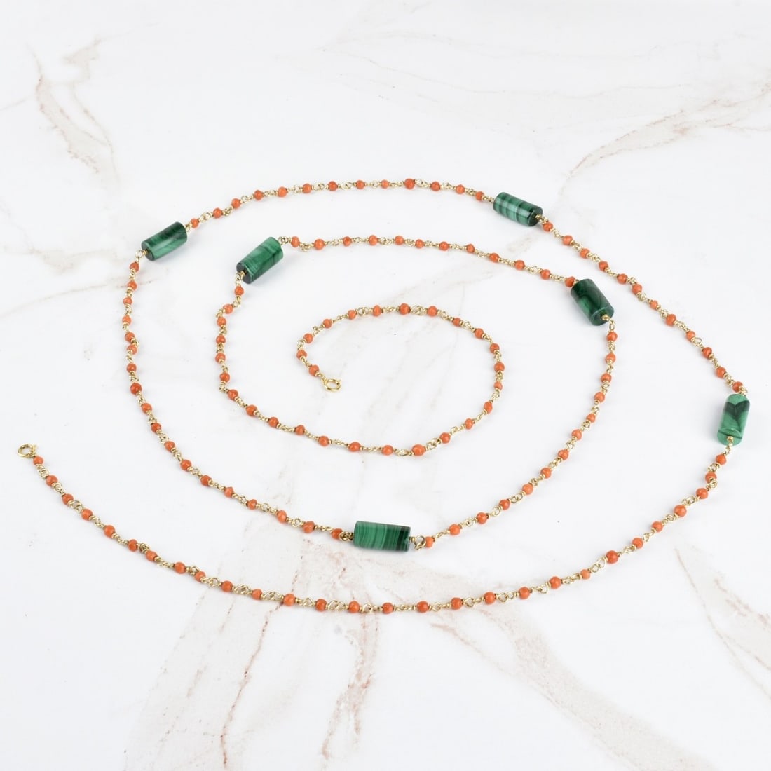 Coral, Malachite and 14K Long Necklace: Vintage Italian Red Coral Bead, Malachite Bead and 14 Karat Yellow Gold Long Necklace. Clasp stamped 585. Measures 52" L. Approx. weight: 35.46 grams. Kodner Galleries offers phone and absentee