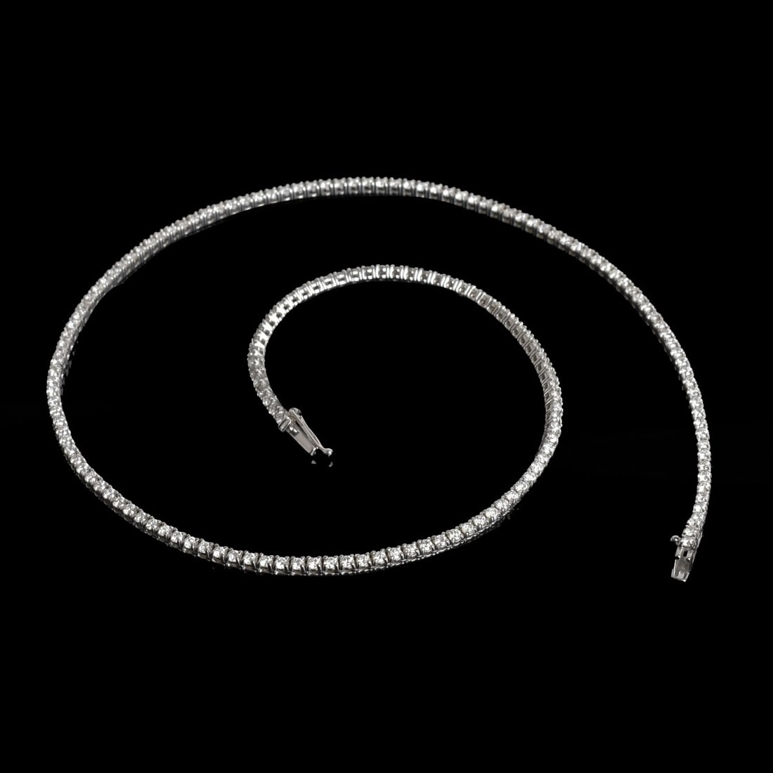 Diamond and 14K Necklace: Approx. 7.0 Carat TW One Hundred Seventy Three Round Brilliant Cut Diamond and 14 Karat White Gold Riviera Necklace. Diamonds F-G color, VS2-SI1 clarity. Measures 17" L. Approx. weight: 14.23 grams.