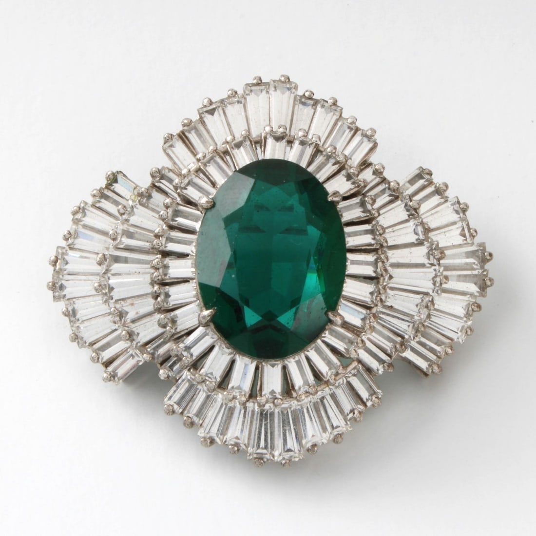 Harry Winston Design Fashion Brooch: Vintage Harry Winston Design Sterling Silver (tested) Fashion Brooch Set with Oval Cut Faux Emerald and Baguette Cut Cubic Zirconias. Measures 1-1/2" H, 1-3/4" W. Approx. weight: 23.56 grams. Kodner G