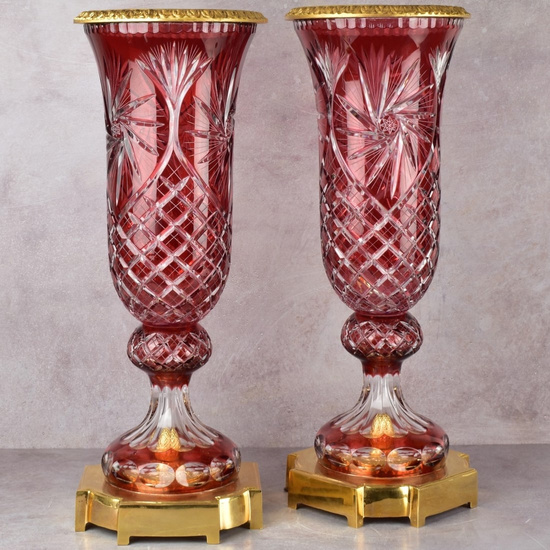 Large Czech Bohemian Vases: Two (2) Large Bohemian Czech Ruby Red Cut to Clear Lead Crystal Footed Vases with Gold Tone Metal Bases and Top Rims. Measures: 23-3/4" high, bases measures: 8-3/4" square. Kodner Galleries offers pho