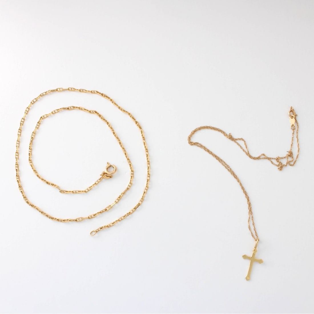 14K Necklaces: Two Vintage Delicate Link 14 Karat Yellow Gold Necklaces. One with Cross Pendant. Stamped 14K, one stamped Italy. Cross pendant measures 7/8" L, 3/8" W, chain measures 16" L. Mariner link necklace
