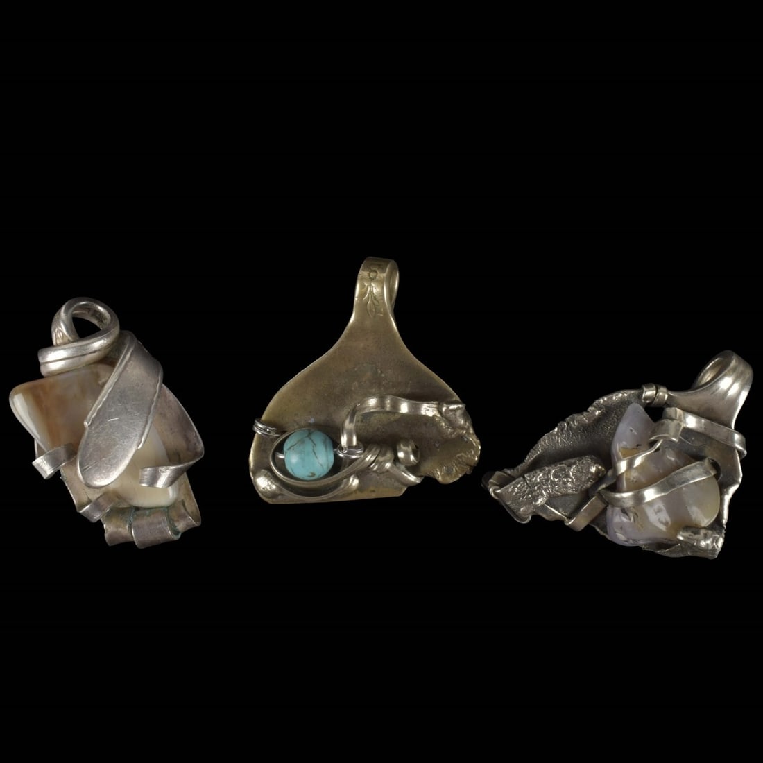 Collection of Silver Plate-Stone Pendants: Collection of Three (3) Silver Plate and Stone Pendants. Largest measures: 2-3/4" long, 1-5/8" wide. Kodner Galleries offers phone and absentee bidding at a low, flat 21% buyer’s premium without sur