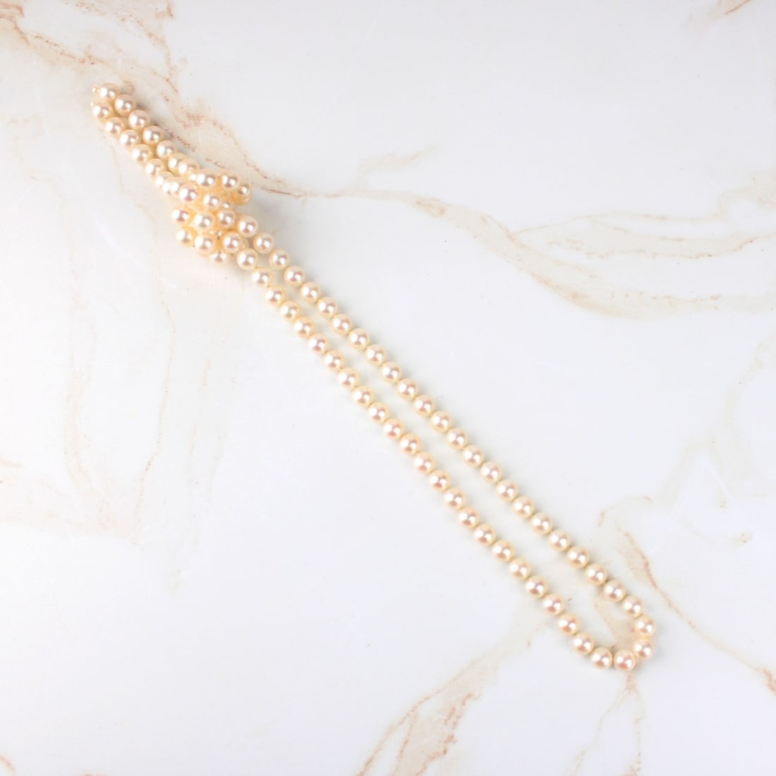 Pearl Necklace: Single Strand 7mm Pearl Tassel Necklace (no clasp). Pearls with good luster and polish. Measures 30-1/2" L. Approx. weight: 53.40 grams. Kodner Galleries offers phone and absentee bidding at a low,