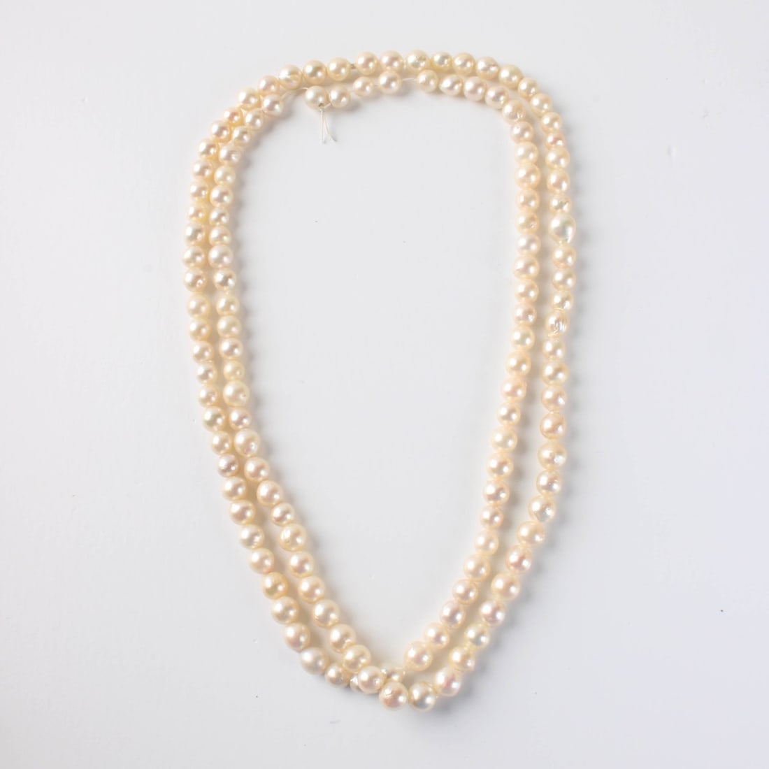 Pearl Necklace: Vintage Single Strand 7mm Baroque Pearl Necklace. Pearls with good luster and polish. Measures 35" L. Approx. weight: 55.91 grams. Kodner Galleries offers phone and absentee bidding at a low, flat