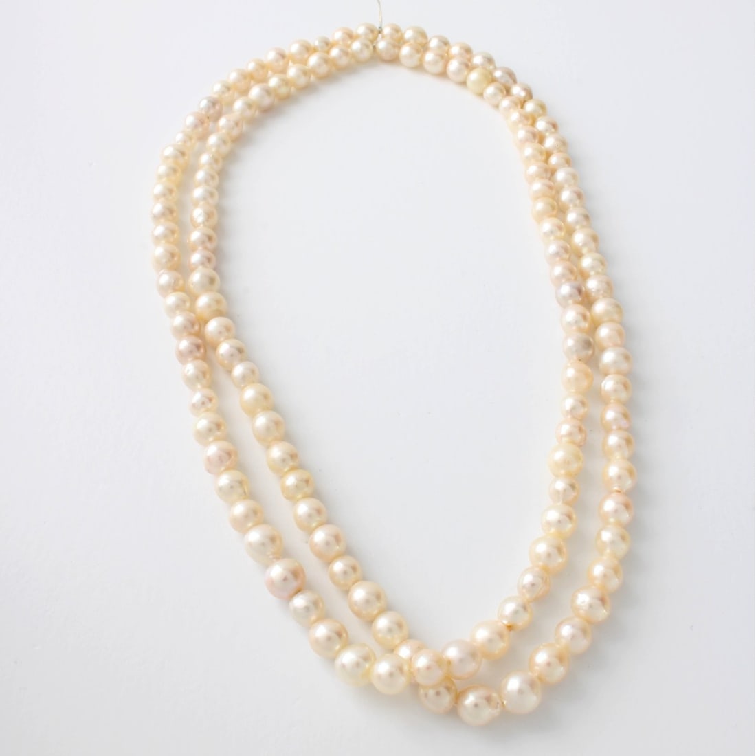 Pearl Necklace: Vintage Single Strand 7mm Baroque Pearl Necklace. Pearls with good luster and polish. Measures 34" L. Approx. weight: 53.61 grams. Kodner Galleries offers phone and absentee bidding at a low, flat