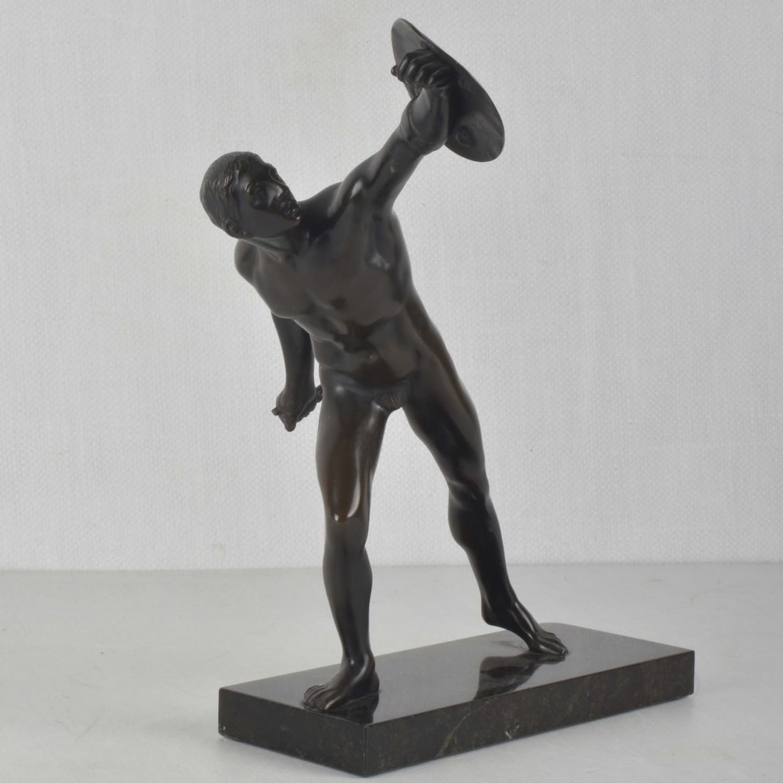 "Borghese Gladiator" Bronze Sculpture: "Borghese Gladiator" Bronze Sculpture on Granite Base After the Antique. Sculpture measures 10" H, 7" W; base measures 8-1/4" L, 3-1/8" W. Kodner Galleries offers phone and absentee bidding at a low,