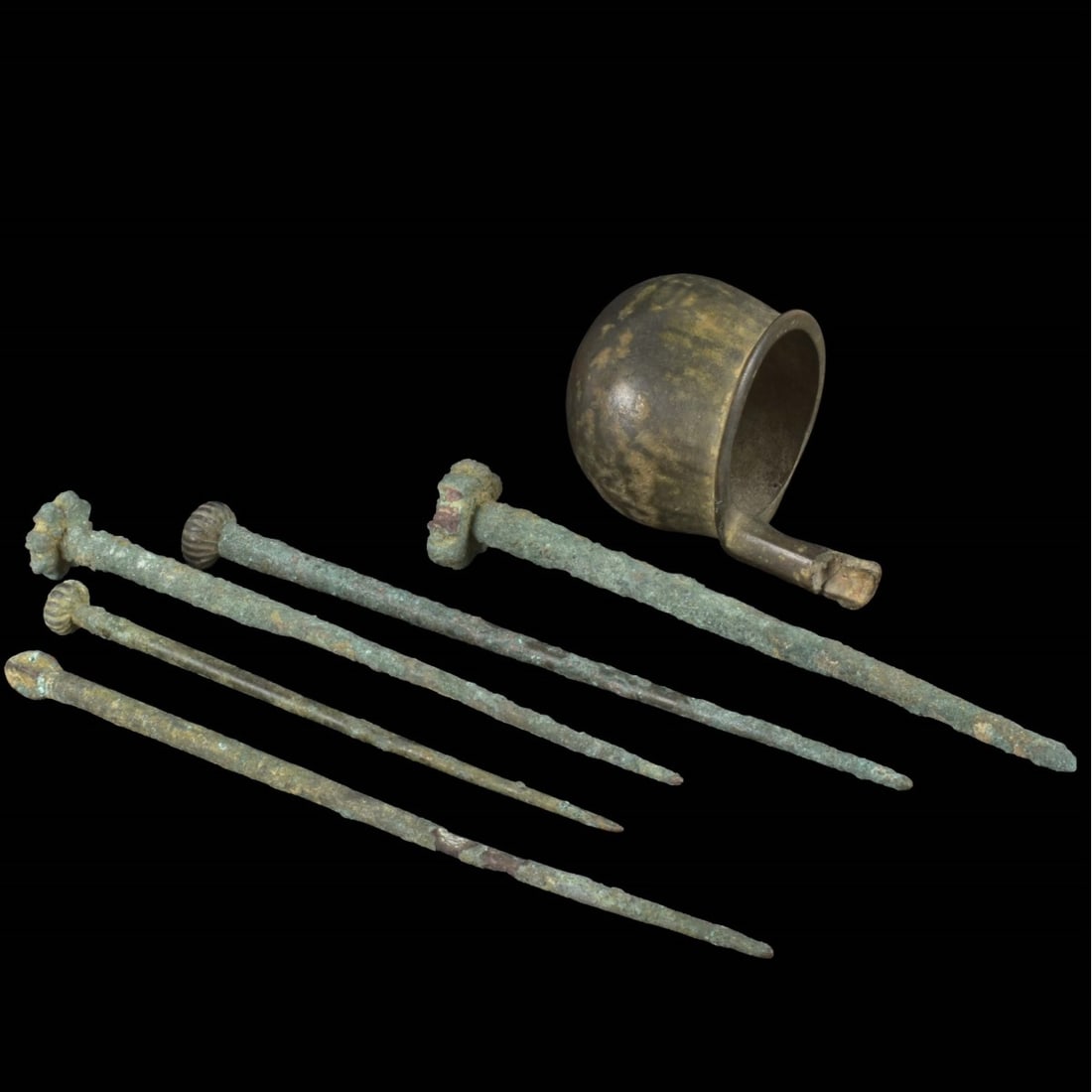 Ancient Roman Bronze Artifacts: Collection of Ancient Roman Bronze Artifacts. To include five pins and a small cup like vessel. Largest pin measures 6" L, 7/8" W (at head). Cup measures 3-1/4" H, 2-1/4" W. Kodner Galleries offers ph
