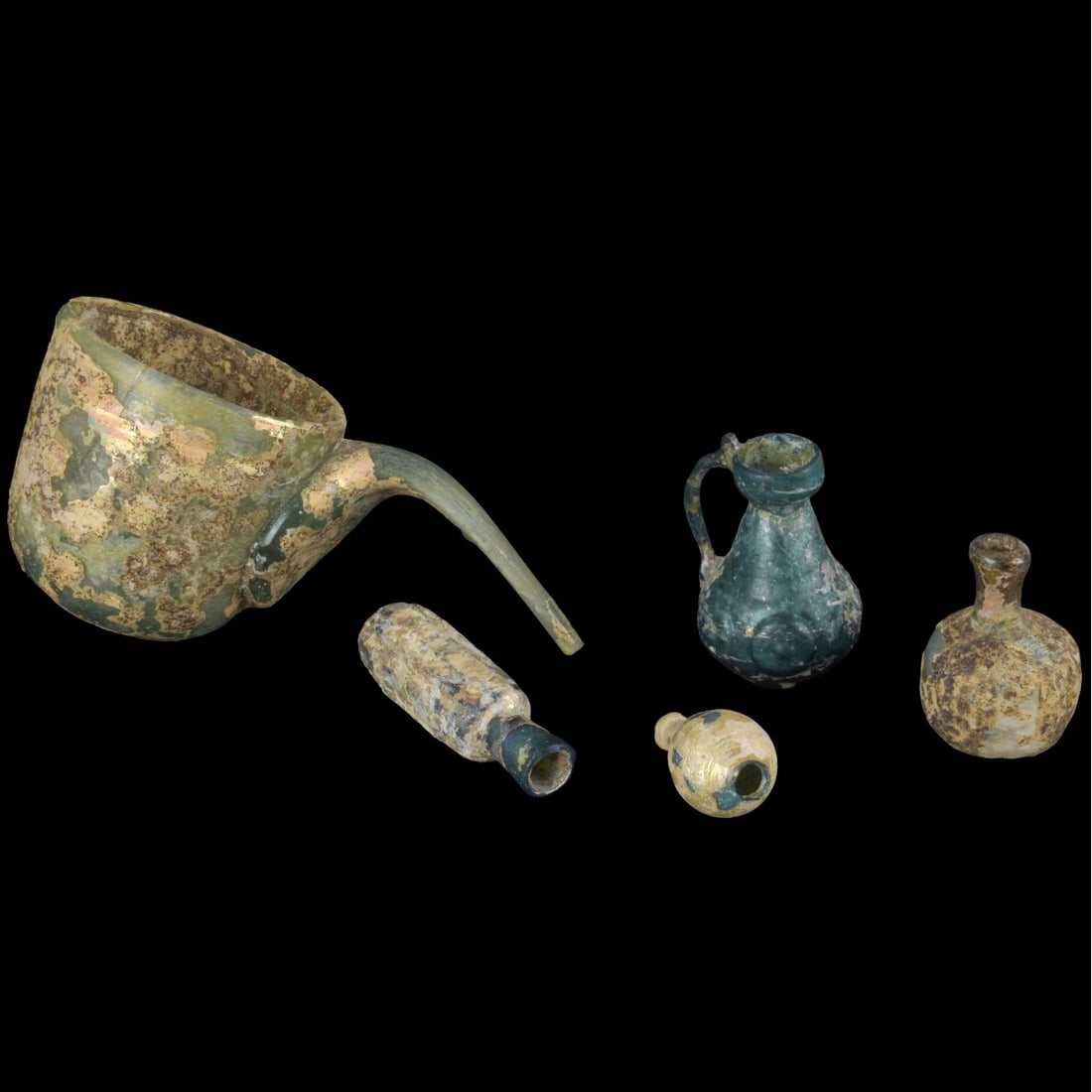 Roman Glass Artifacts: Five Piece Collection of Roman Glass Artifacts. To include a cup, beakers and vessels. Largest (cup) measures 2-5/8" H, 6" W; smallest measures 1-7/8" H, 7/8" W. Kodner Galleries offers phone and