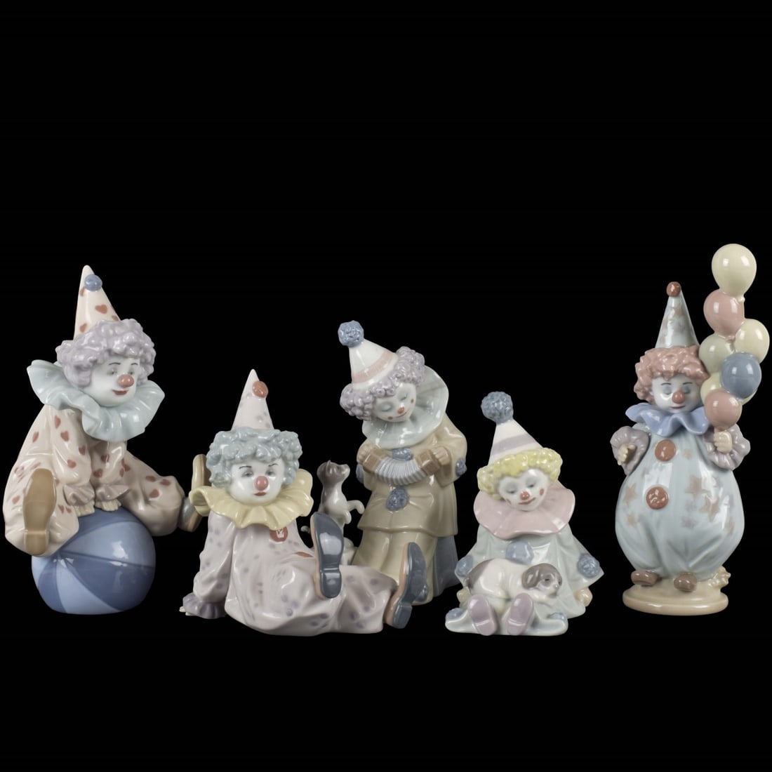 Lladro Porcelain Clown Figures: Collection of Five Lladro Porcelain Clown Figures. Each signed. Tallest (with balloons) measures 7-3/8" H, 2-1/2" W. Kodner Galleries offers phone and absentee bidding at a low, flat 21% buyer’s