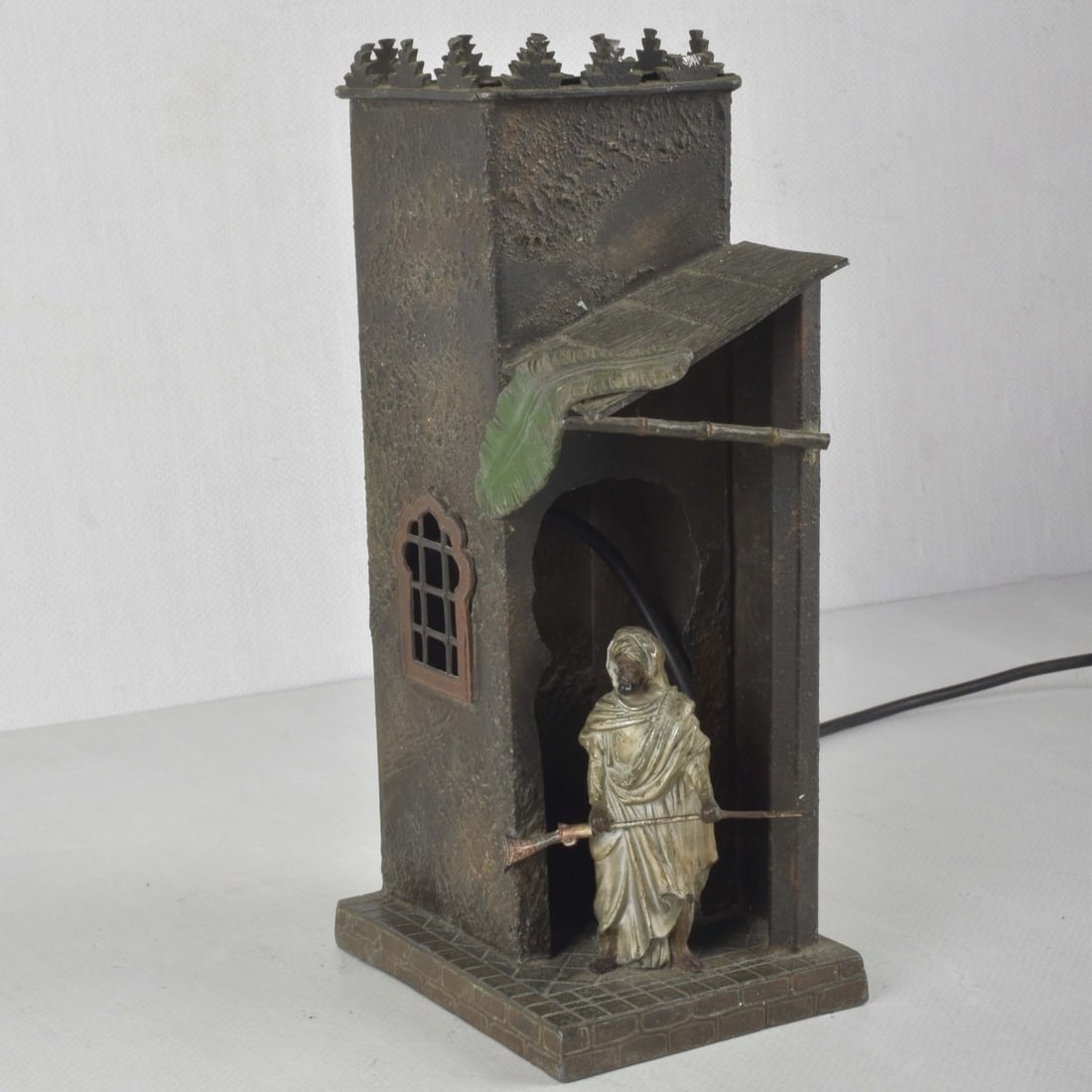Style of Franz Xaver Bergmann, Austrian (1861-1936: Style of Franz Xaver Bergmann, Austrian (1861-1936) Antique Cold-Painted White Metal Table Lamp. Modeled as an Arab man standing with a riffle in a doorway. Measures: 12-1/2" high, base