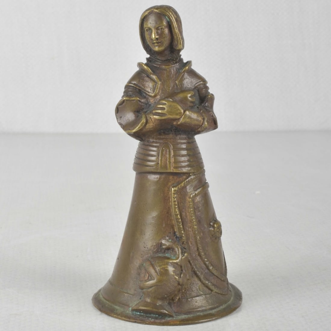 Early 20th Century Joan of Arc Sculpture: Early 20th Century Joan of Arc Bonze Sculpture in the Form of a Bell. Measures: 4-3/4" high, base measures: 2-3/8" diameter. Kodner Galleries offers phone and absentee bidding at a low, flat 21%