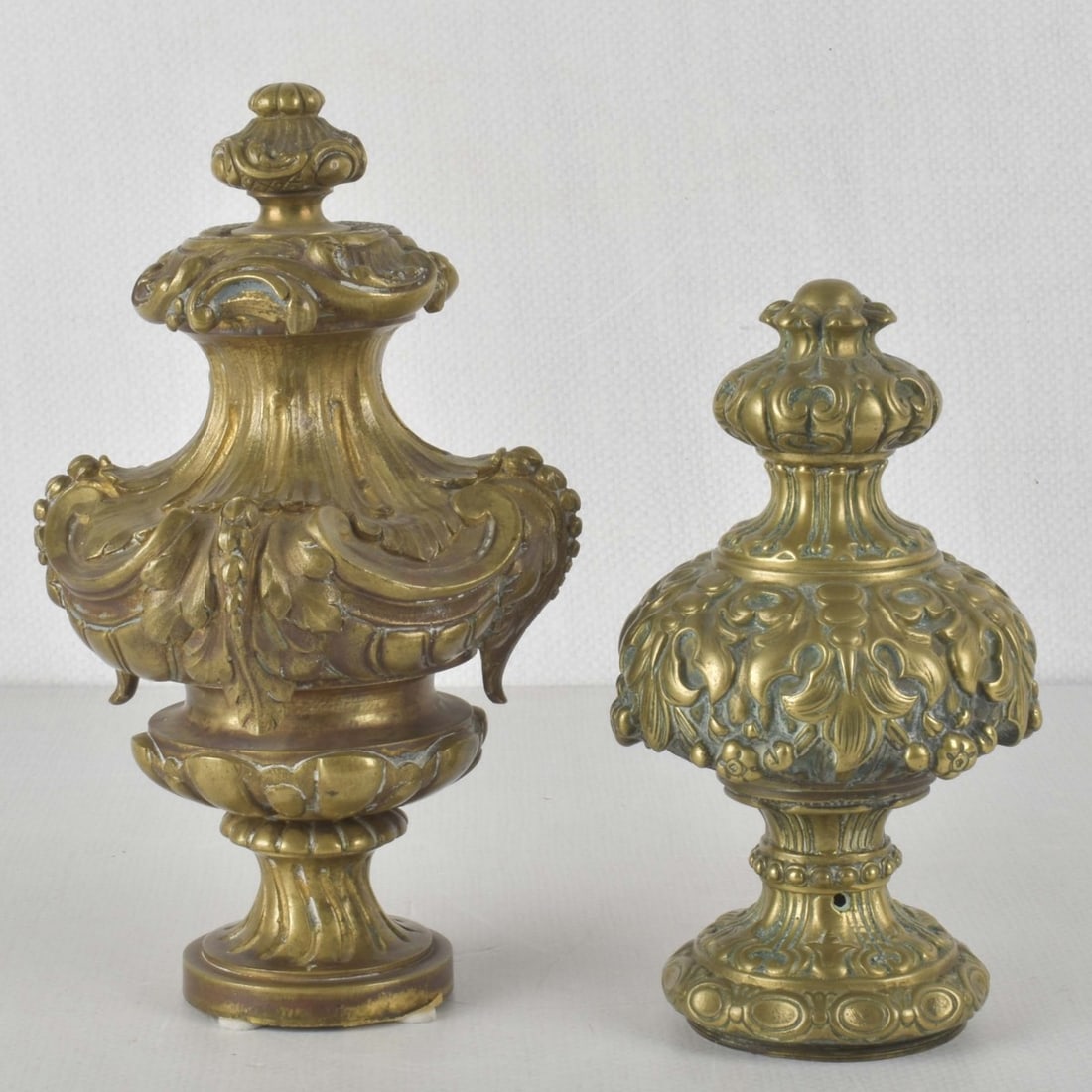 Vintage Newell Posts: Two (2) Vintage Newell Posts Each with a Floral Design. Tallest measures: 8-1/2" high, 5" diameter, shortest measures: 6-3/4" high, 3-1/2" diameter. Kodner Galleries offers phone and absentee bidding