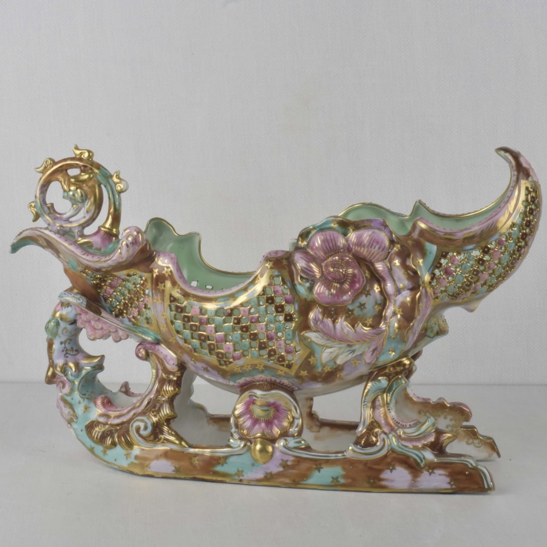 Hand Painted Porcelain Reticulated Bowl: Probably J. Fischer Budapest Hungarian Vintage Hand Painted Porcelain Reticulated Bowl in the Form of a Sleigh with a Flora Motif and Gold Gilding. Measures: 10-3/4" high, 17-1/2" long, 6-1/4" wide. K