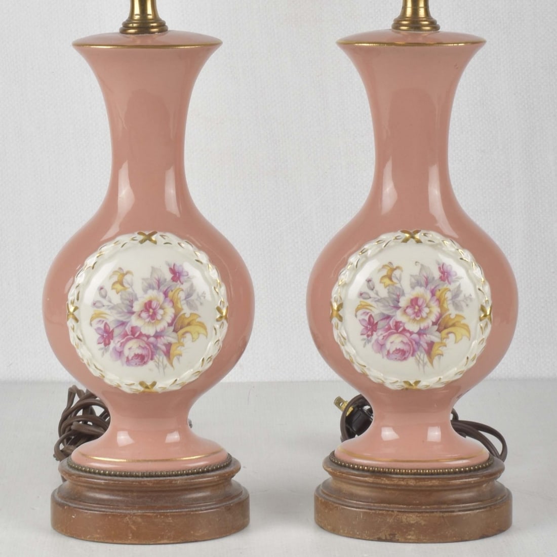 Vintage Pair Porcelain Boudoir Lamps: Vintage Pair of Porcelain Boudoir Lamps Decorated with Flower Sprays on a Pink Ground with Gold Highlights. Porcelain portion measures: 10-1/2" high, 4-1/2" wide, 2-1/2" deep, overall from bottom to t