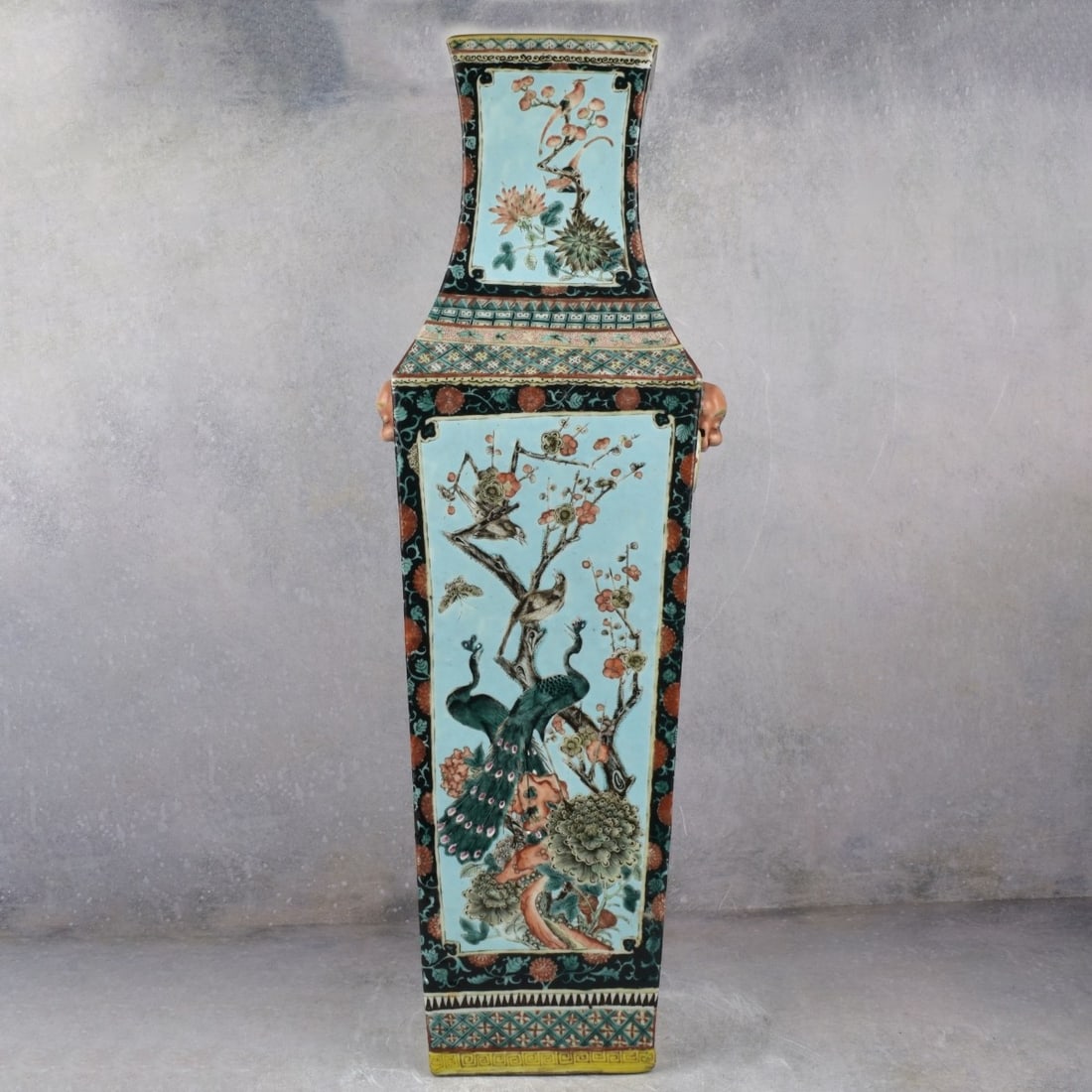 Large Chinese Famille Verte Vase: Large Chinese Famille Verte Quadrangular Porcelain Vase. 19th/20th century. Decorated with peacocks, birds and cherry blossoms, mask and ring handles. Measures: 27-3/4" H, 7-3/8" Square. Kodner Galler