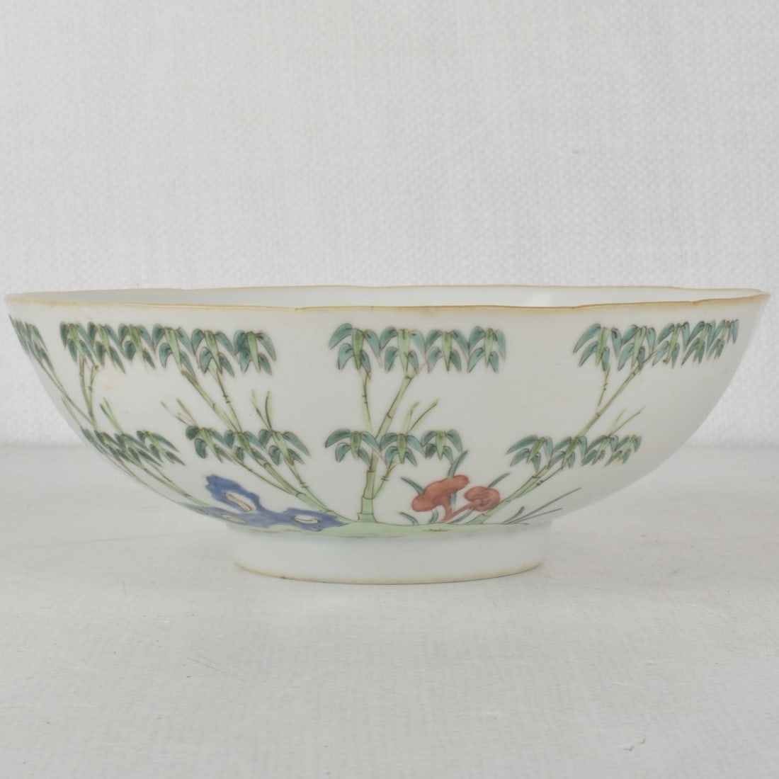 18/19th Century Chinese Porcelain Bowl: 18/19th Century Chinese Porcelain Bowl. Decorated with flowers and bamboo and a central medallion of peaches and leaves with bottom marked with the endless knot mark. Measures: 2-3/4" high, 7-3/4"