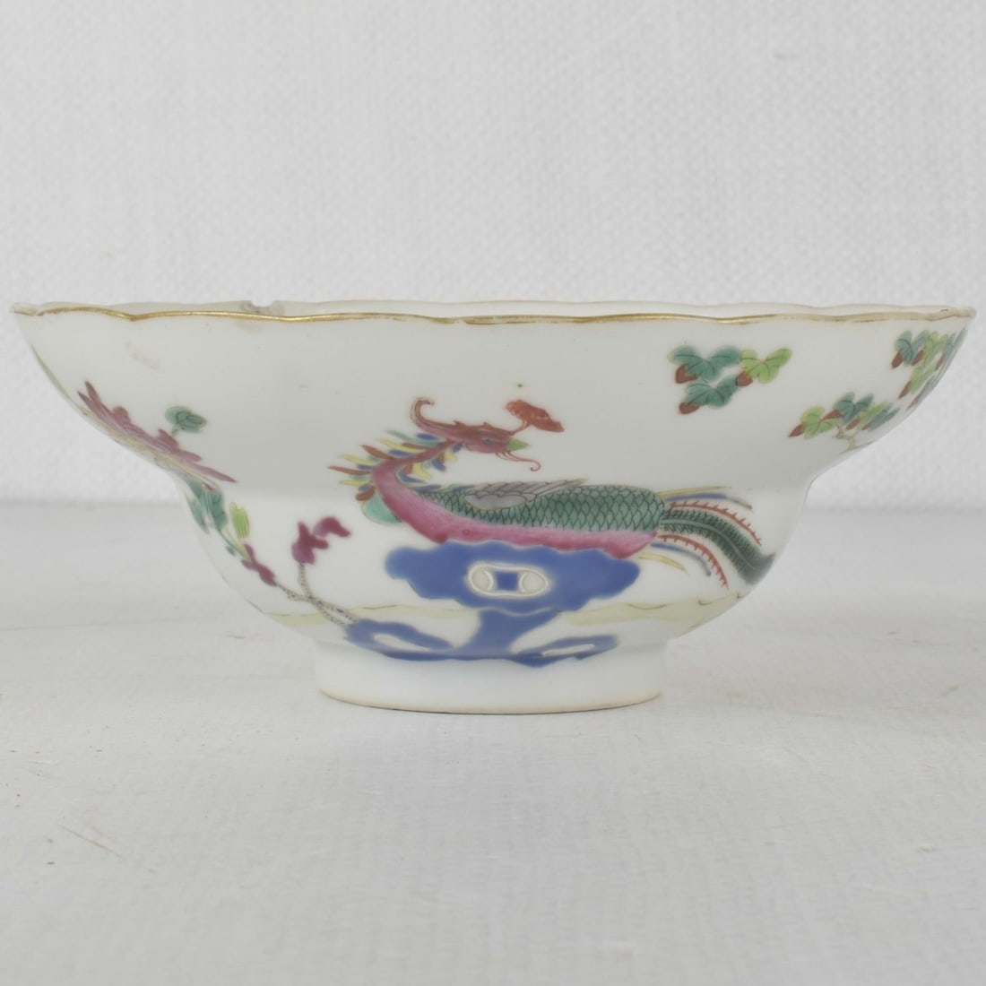 18/19th Century Chinese Porcelain Bowl: 18/19th Century Chinese Porcelain Bowl. Decorated with flowers, peacock and birds under a lotus tree with a central medallion of peaches and leaves, the bottom bears the Quing Dynasty Mark. Measures: