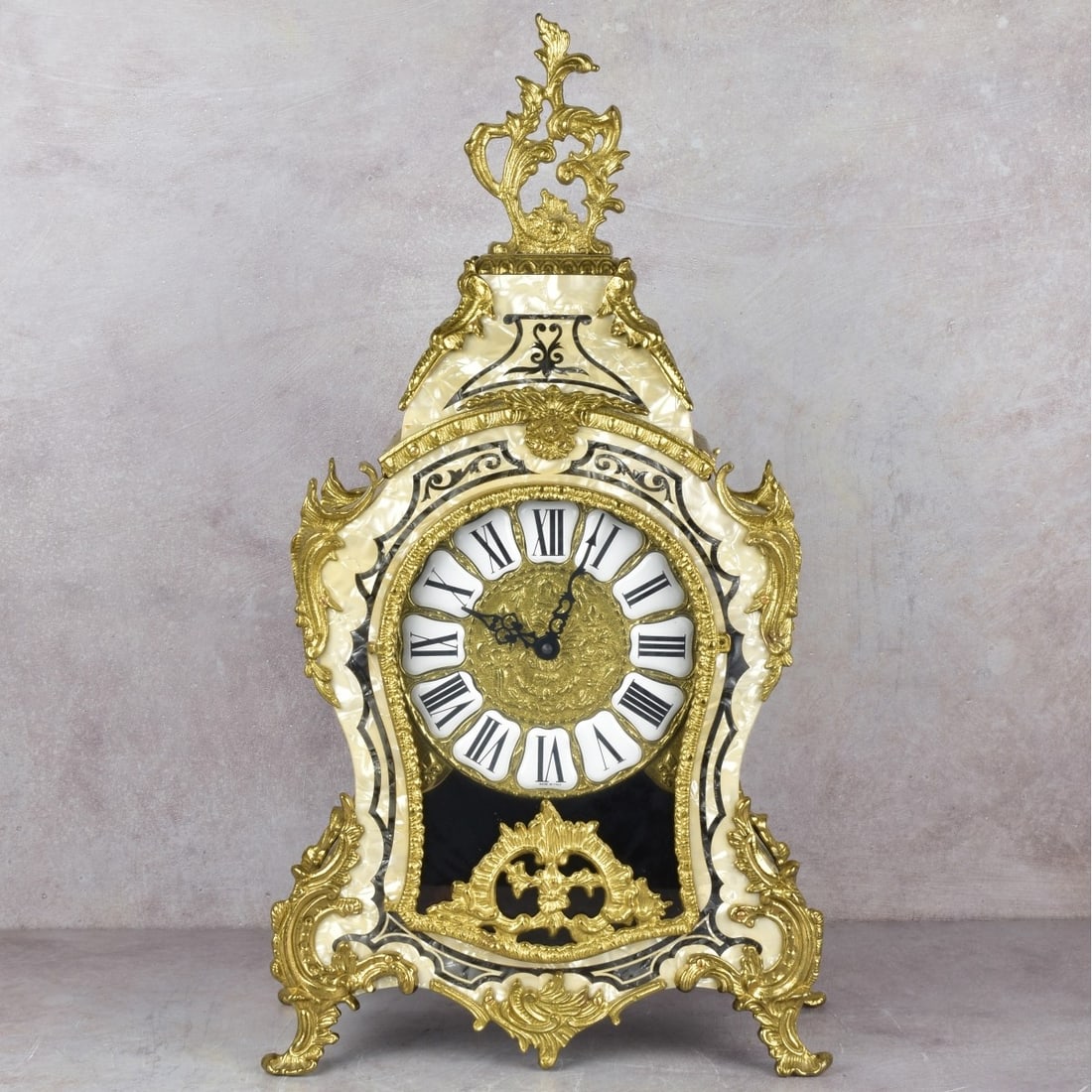 Modern Louis XIV Style French Clock: Modern Louis XIV Style French Bracket Clock with Brass Ormolu Mounts and Mother of Pearl Inlays. Battery operated. Measures: 22-1/2" high, 12" wide, 6" deep. Kodner Galleries offers phone and