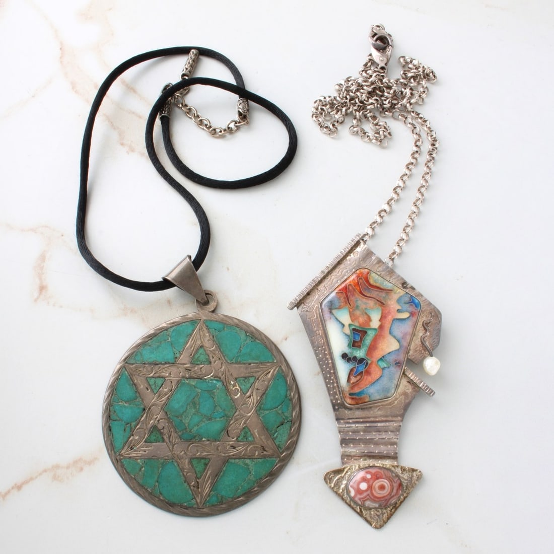 Sterling Pendants: C. R. Dunetz 1988 Sterling Silver, Enamel, Pearl and Agate Pendant Necklace together with Sterling Silver and Turquoise Star of David Pendant with Black Silk Cord Necklace with Sterling Clasp. Dunetz 