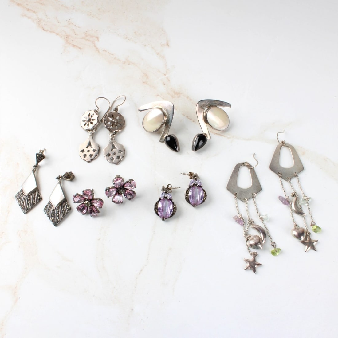 Sterling Earrings: Six (6) Pair of Vintage Sterling Silver Earrings. Variously accented with marcasites, color stones, mother of pearl and black onyx. Various styles and makers. Approx. total weight: 54.25 grams.