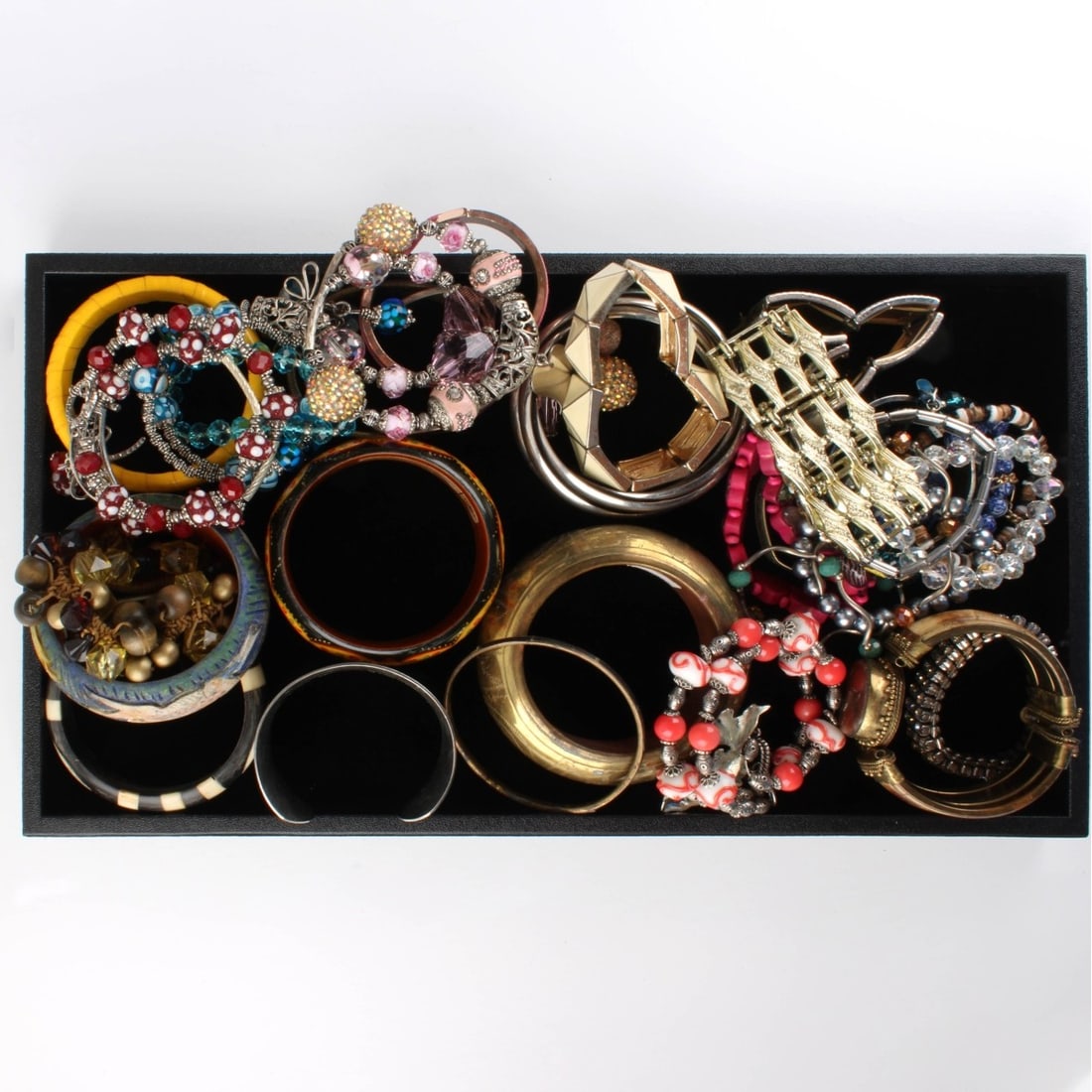Tray Lot of Fashion Bracelets: Tray Lot of Vintage Fashion Bracelets. Variously accented with hardstones, bone, wood, enamel, faux pearls, faux pearls and more. Various makers and styles. Kodner Galleries offers phone and absentee
