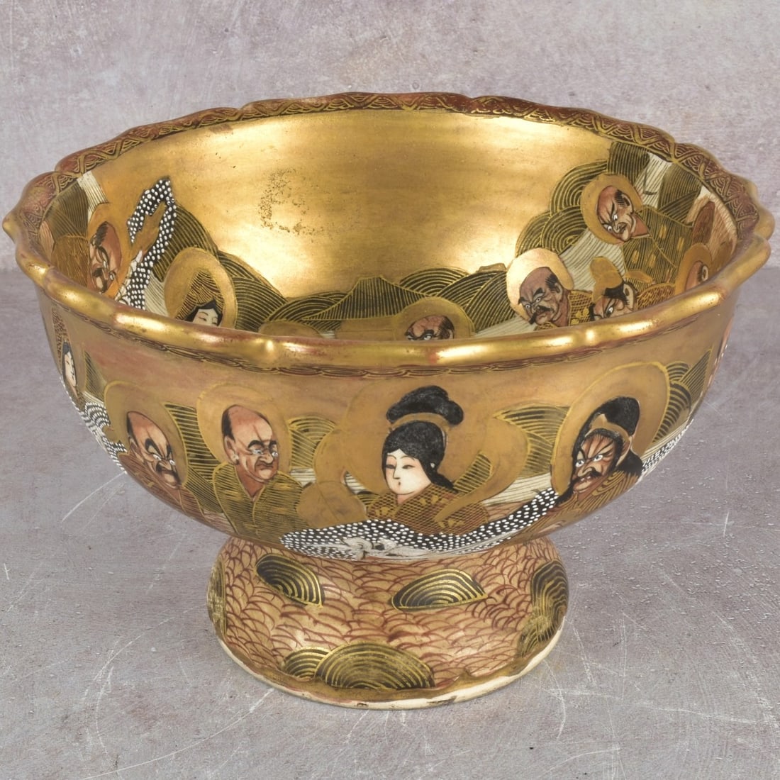 Japanese Meiji Pedestal Satsuma Bowl: Antique Japanese Meiji Period (1868-1912) Satsuma Moriage Pottery Ware Pedestal Bowl in Heavy Gilded Polychromatic Enamels of Figures with a Scallop Top Rim. Signature chop mark to the bottom.