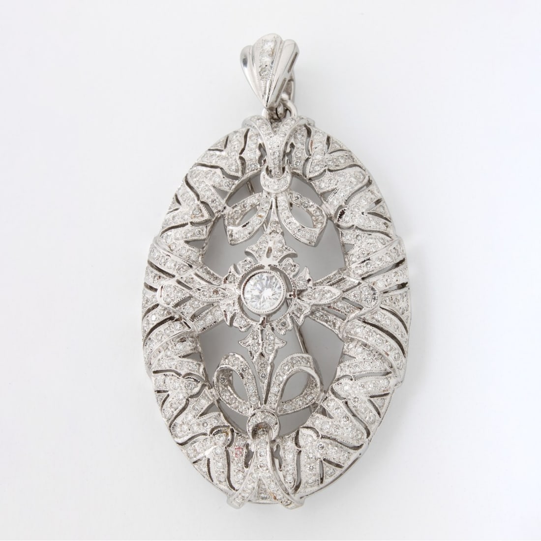 Diamond and 18K Pendant / Brooch: Vintage Victorian Design Approx. 4.0 Carat TW Round Brilliant Cut Diamond and Filigree 18 Karat White Gold Pendant / Brooch. Set in the center with an approx. .50 carat round brilliant cut diamond. Di