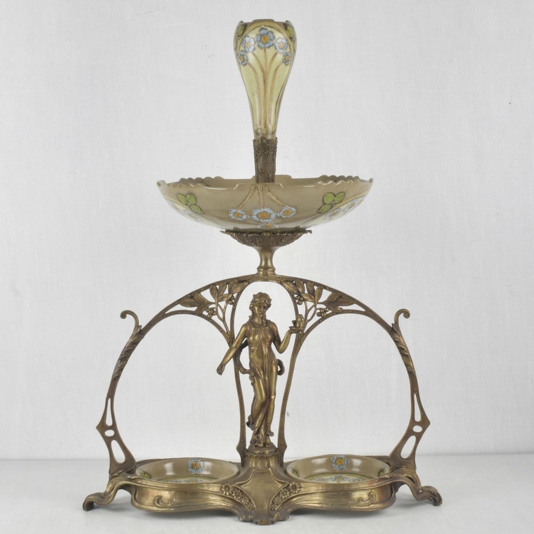 Art Nouveau Style Epergne: Art Nouveau Style Gilt Metal and Porcelain Epergne. Measures: 24" high, 18" wide, 7" deep. Kodner Galleries offers phone and absentee bidding at a low, flat 21% buyer?s premium without surcharge or