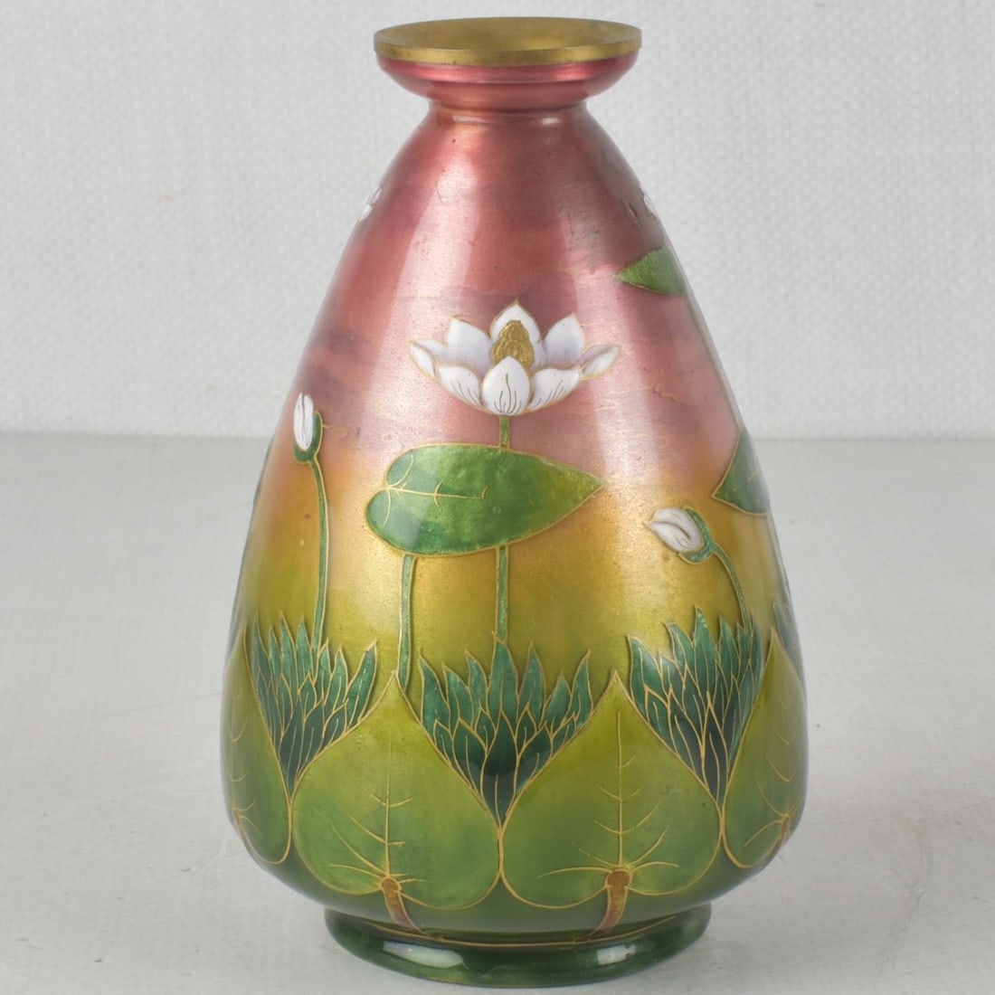 French Limoges Foil Floral Pattern Vase: French Limoges Foil Floral Pattern Vase. Decorated with lotus flowers on a green and pink copper vase. Measures: 5-7/8" high, 3-1/2" diameter. Kodner Galleries offers phone and absentee bidding at a