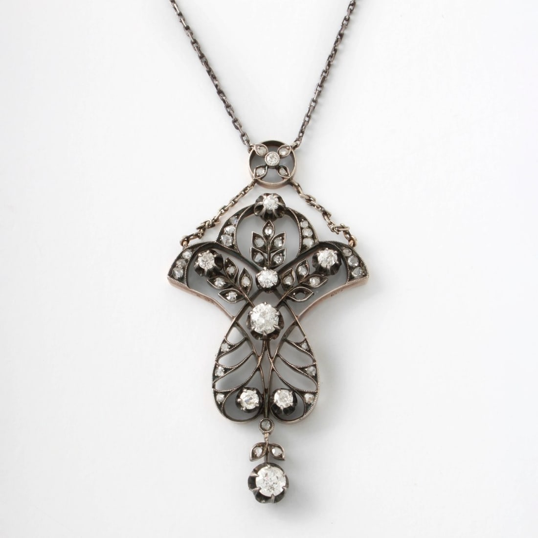 Russian Diamond and 14K Pendant: Antique Russian Approx. 1.60 Carat TW Old European Cut Diamond and Filigree 14 Karat White Gold Pendant with a White Metal Chain. Diamonds E-F color, SI2 clarity. Russian 56 gold mark. Illegible